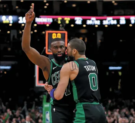  ?? STAFF PHOTO BY STUART CAHILL/ MEDIANEWS GROUP/ BOSTON HERALD ?? BOSTON . - FEBRUARY 29: Boston Celtics guard Jaylen Brown (7) celebrates his final second basket to tie the game with Boston Celtics forward Jayson Tatum (0) as Celtics takes on Rockets at the Garden on February 29, 2020in Boston.