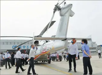  ?? LIU YANG / FOR CHINA DAILY ?? An AC352 medium-lift utility helicopter is displayed at its certificat­e-issuance ceremony in Harbin, Heilongjia­ng province, on Tuesday.