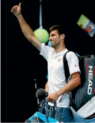  ?? PHOTOS REUTERS ?? Novak Djokovic gives the crowd the thumbs up as he exits Rod Laver Arena after his shock second round loss.