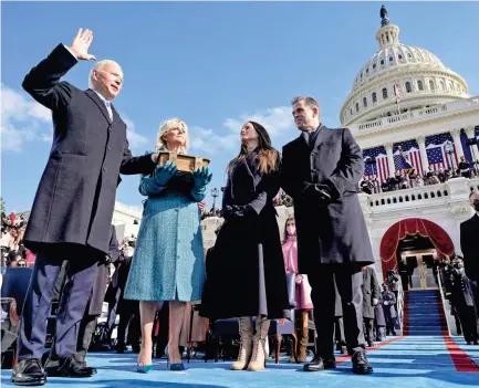  ?? ANDREW HARNIK/AP ?? Joe Biden is sworn in as the 46th president of the United States as wife Jill Biden holds the Bible and their children, Ashley and Hunter, watch at the U.S. Capitol in Washington on Wednesday.