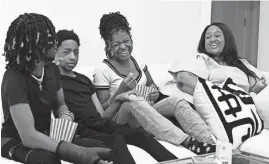  ?? PHOTOS BY MARK ZALESKI/THE TENNESSEAN ?? Eric, from left, Ethan and Jada Fitih and their mother, Samantha Sharpe, joke around before watching a movie at their home in Nashville. Sharpe, a local digital creator, is passionate about social media safety, especially for her three teenage children.