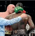  ??  ?? Tyson Fury and Deontay Wilder could not be separated when the fought in Los Angeles.