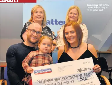  ??  ?? Generous The family present the cheque to hospital staff