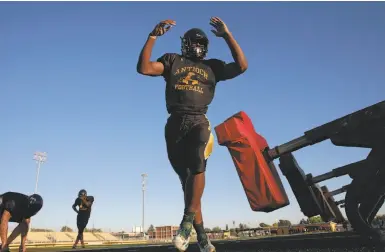  ?? Photos by Michael Macor / The Chronicle ?? Antioch High School running back Najee Harris, 18, works on his blocking skills during practice drills.