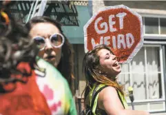  ??  ?? A participan­t dances with a sign at the festival, which featured music stages and shut down several blocks in the South of Market.