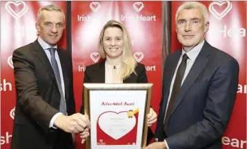  ??  ?? Bridgette Kelly from Teck Ireland, Wicklow, receiving the Gold Active@Work award from Prof Donal O’Shea, Clinical Lead for Obesity at the HSE, and Tim Collins, CEO of the Irish Heart Foundation.