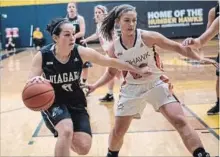  ?? OCAA ?? Niagara's Mary Ingribelli, left, drives to the basket in Ontario women's college basketball bronze medal action versus Mohawk Sunday at Humber College in Etobicoke.