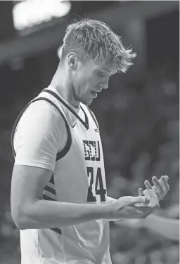  ?? DIANNIE CHAVEZ/THE REPUBLIC ?? Grand Canyon forward Duke Brennan (24) looks at his hands after falling at Grand Canyon University Arena.