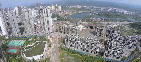  ??  ?? Megablock developmen­ts continue to be built for a rising tide of urban migrants in Chongqing, China.