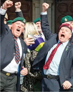  ??  ?? Punching the air: Veterans celebratin­g the verdict