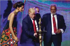  ??  ?? EDISON: Republican presidenti­al candidate Donald Trump lights a diya before delivering remarks to the Republican Hindu Coalition. — AP