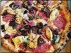  ?? COURTESY OF BOB TOWNSEND ?? Amori Mio pizza with fresh mozzarella, roasted artichokes, salami, mushrooms, black olives, Pecorino Romano and basil.