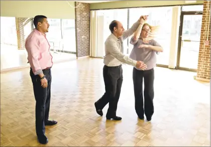  ?? H John Voorhees III / Hearst Connecticu­t Media ?? Arthur Murray Dance Center instructor Laz Chavez, left, observes Carlo Greco, of New Milford, as he dances with instructor Samantha Lovetere at the Danbury studio. The dance studio offered discounted dance lessons to benefit Housatonic Habitat for Humanity on Friday.