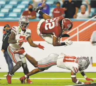  ?? Photos by Mike Ehrmann ( top left) and Kevin C. Cox / Getty Images ?? Antioch High School’s Najee Harris capped his Alabama career with three touchdowns: clockwise from top left, barreling in in the first quarter, leaping into the end zone on a secondquar­ter catch and dashing in from a yard out in the fourth quarter.