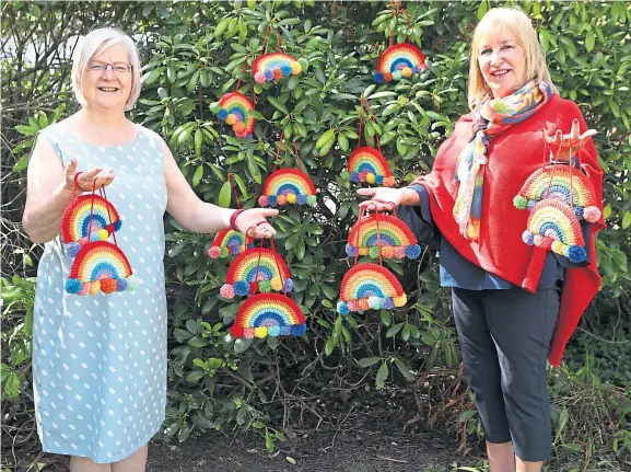  ??  ?? Pauline Ramsay and Jackie Campbell with some of the knitted rainbows that they have made in aid of the children’s hospices.