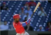  ?? NICK WASS — THE ASSOCIATED PRESS ?? The Phillies’ Andrew McCutchen follows through with an RBI single during the eighth inning against the Washington Nationals, Thursday, in Washington. The Phillies’ J.T. Realmuto scored on the play. The Phillies won 7-6.
