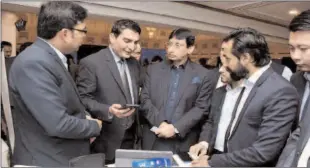  ?? -APP ?? ISLAMABAD
Federal Minister for IT and Telecommun­ication Syed Amin ul Haque visited a smart phones stall during the launching ceremony of "GSMA Smartphone for All".