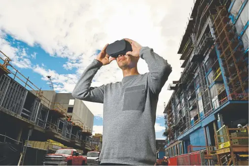  ?? Photos by Hyoung Chang, The Denver Post ?? Charles Hellwig of Cinearc Creative in Denver uses high-tech goggles for a virtual reality tour of not-yet-existing condos in October. The Lakehouse Denver won’t be ready for move-in until summer 2019, but the sales team at the condo developmen­t is using the technology to show prospectiv­e buyers the units in the meantime.