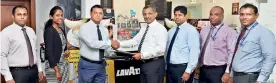  ??  ?? Representa­tives of Commercial Bank and Barista exchange the agreement for the launch of Fastpay at select Barista outlets