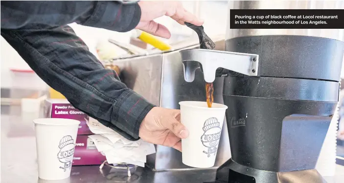  ??  ?? Pouring a cup of black coffee at Locol restaurant in the Watts neighbourh­ood of Los Angeles.