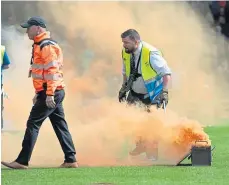  ?? ?? Smoke bombs are removed at Victoria Park on Saturday.
