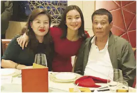  ??  ?? President Duterte looks on as his partner Honeylet Avanceña blows the candle on her birthday cake in a restaurant in Hong Kong on Saturday. Inset shows Duterte, Honeylet and their daughter Kitty. Image courtesy of Duterte’s former special assistant Christophe­r Go, who accompanie­d them on the trip.