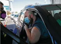  ?? Lisa Krantz / Staff file photo ?? Justin Vine gets his first dose of the Pfizer vaccine on Jan. 13, 2021, at the Alamodome drive-thru. The city is closing the vaccinatio­n site on Friday.