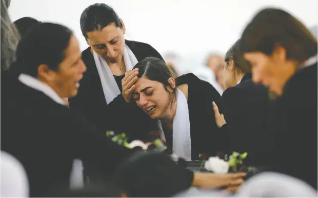  ?? JALAA MAREY/AFP VIA GETTY IMAGES ?? An Israeli Druze woman cries before the body of 17-year-old Tiran Fero during his funeral ceremony Thursday in Daliyat al-karmel. The body of Fero, who was wounded in a car accident, was snatched from a West Bank hospital by Palestinia­n militants before being returned to his family.