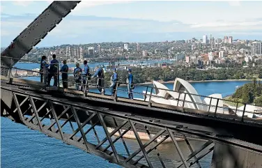  ??  ?? Climbers can now cross the full length of the Sydney Harbour Bridge for the first time.