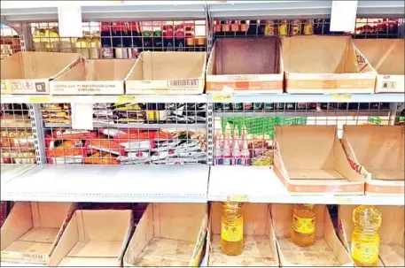  ?? THE JAKARTA POST ?? A shelf stands almost empty of packaged cooking oil on January 27 at a supermarke­t in Bekasi, West Java, Indonesia.