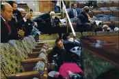  ?? ANDREW HARNIK — ASSOCIATED PRESS ?? People shelter in the House gallery as protesters try to break into the House Chamber at the U.S. Capitol on Wednesday in Washington.