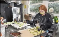  ?? ?? Dee Wagner of San Rafael brushes fresh vegetables with olive oil while cooking meals in San Rafael.