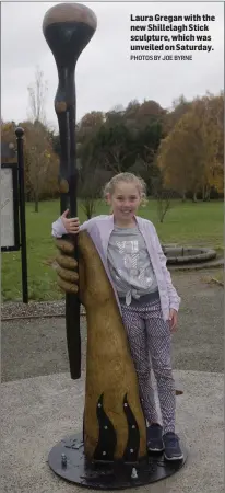  ??  ?? Laura Gregan with the new Shillelagh Stick sculpture, which was unveiled on Saturday. PHOTOS BY JOE BYRNE