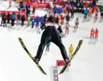  ?? Dmitri Lovetsky / Associated Press ?? Norway’s Maren Lundby soars through the air on her way to winning the gold medal in the women’s ski jumping normal hill event Monday at the Winter Olympics in Pyeongchan­g, South Korea. Lundy nailed a jump of 110 meters for 264.6 points.