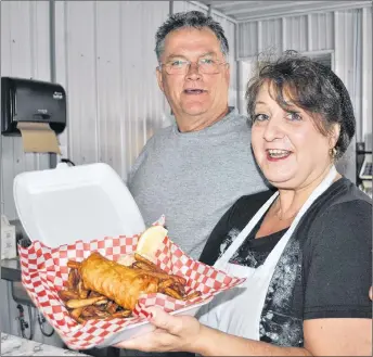  ?? CAROL DUNN/THE NEWS ?? Steeltown Take-out owner Mike MacKenzie and cook Deanie Phalen with fish and chips, one of the offerings at the new restaurant.