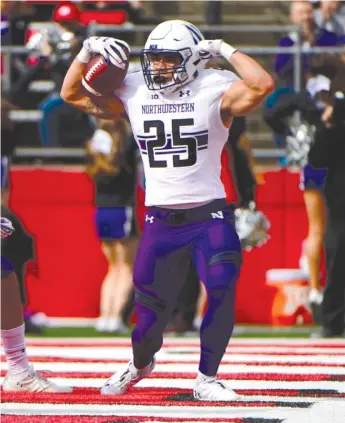  ?? GETTY IMAGES ?? Isaiah Bowser (24 carries for 108 yards) flexed his muscles for the Cats, scoring both of their touchdowns. This one came on a three-yard run in the first quarter and the other from five yards out in the fourth.