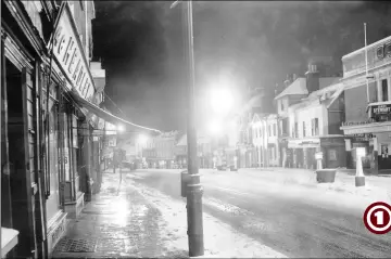  ?? (All photos from 1957) ?? A nostalgic view showing snowfall in the Lower High Street at a time when traffic was permitted down the high street, something that was much better for business compared to the pedestrian-only area it is today during office hours