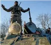  ?? AP ?? Ukrainian soldiers stand atop an APC near Urzuf, south coast of Azov sea, eastern Ukraine.