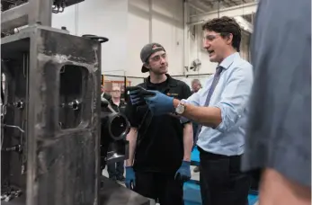  ?? CP PHOTO ?? Prime Minister Justin Trudeau speaks with a general machining apprentice, Justin Moore, at the Frank Hasenfratz Centre of Excellence in Manufactur­ing in Guelph, Ont. on Tuesday.