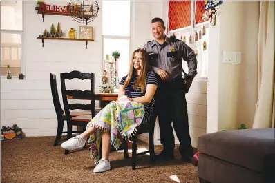  ?? WADE VANDERVORT ?? Nevada Highway Patrol Trooper Jason Lareaux and his daughter Allie Hathaway-lareaux pose for a photo Tuesday in their home. Allie has been making fleece blankets that her father and other NHP officers on patrol can give to children in need.