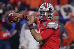  ?? Rick Scuteri/Associated Press ?? ■ Ohio State quarterbac­k Justin Fields throws a pass against Clemson on Dec. 28, 2019, during the Fiesta Bowl NCAA football playoff semifinal in Glendale, Ariz.