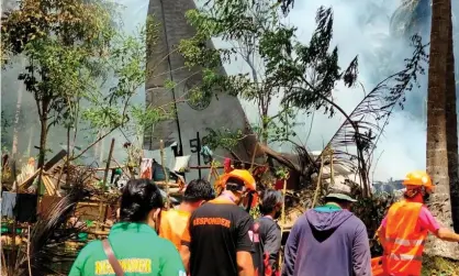  ?? Photograph: Philippine­s Army Jft Sulu/Reuters ?? Emergency workers attend the scene after a Philippine­s air force C-plane carrying troops crashed in Sulu province on Sunday.