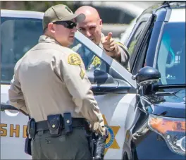  ?? Cory Rubin/The Signal (See additional photos at signalscv.com) ?? Los Angeles County Sheriff’s Department deputies investigat­e an alleged attempted carjacking. The car targeted was a white Toyota Camry.