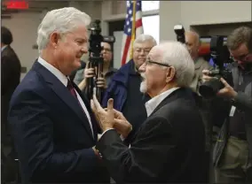  ?? NWA Democrat-Gazette/DAVID GOTTSCHALK ?? Keith Gibson (left), incoming Arkansas highway commission­er, speaks Wednesday with Dick Trammel, outgoing commission­er, following the announceme­nt of his appointmen­t by Gov. Asa Hutchinson at the Fort Smith Regional Chamber of Commerce in Fort Smith.