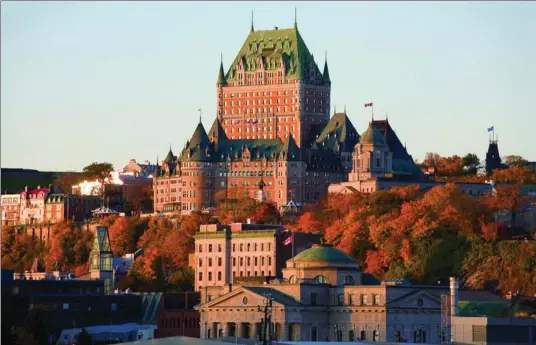  ?? LUC-ANTOINE COUTURIER, QUEBEC CITY TOURISM ?? The Chateau Frontenac looms impressive­ly over the old town and lower town.