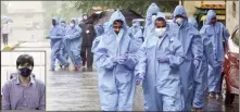  ??  ?? Health workers leave after conducting medical checkups of the residents in a COVID-19 containmen­t zone in Mumbai on Wednesday. (Inset) Abhijit Bangar