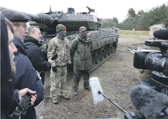  ?? PHOTOGRAPH: REUTERS ?? ▼ Ukrainian soldiers talk to the media after taking part in training on Germany’s Leopard tanks
