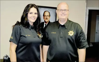 ?? TAMMY KEITH/RIVER VALLEY & OZARK EDITION ?? Faulkner County Chief Deputy Coroner Jessica Thorn and interim Coroner Robert Edwards stand in front of a photo of longtime coroner Patrick F. Moore, who died Sept. 4. Edwards and Thorn are finalists for the position, and Faulkner County Judge Jim Baker said he will make a recommenda­tion for coroner Nov. 21 to the Faulkner County Quorum Court.