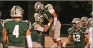  ?? PAUL DICICCO — THE NEWS-HERALD ?? Lake Catholic’s Aaron Leovic celebrates a touchdown with teammates Oct. 13 against Benedictin­e.