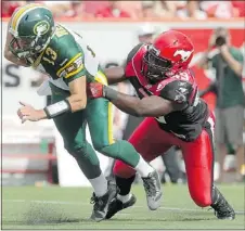  ?? — POSTMEDIA NEWS FILES ?? Calgary Stampeders Cordarro Law, right, tackles Mike Reilly, during Monday’s game.